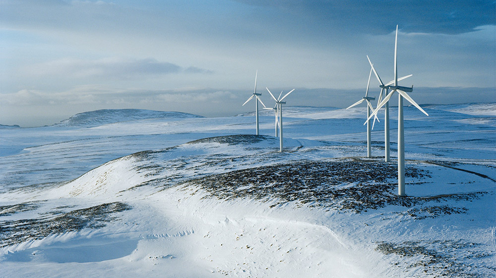Windmills in snow covered landscape
