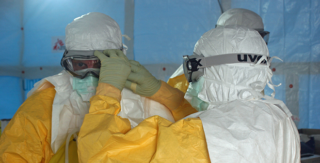 Volunteers putting on their personal protective equipment before taking care of Ebola patients.