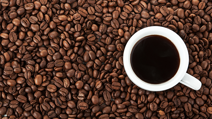 Cup for espresso on coffee beans background